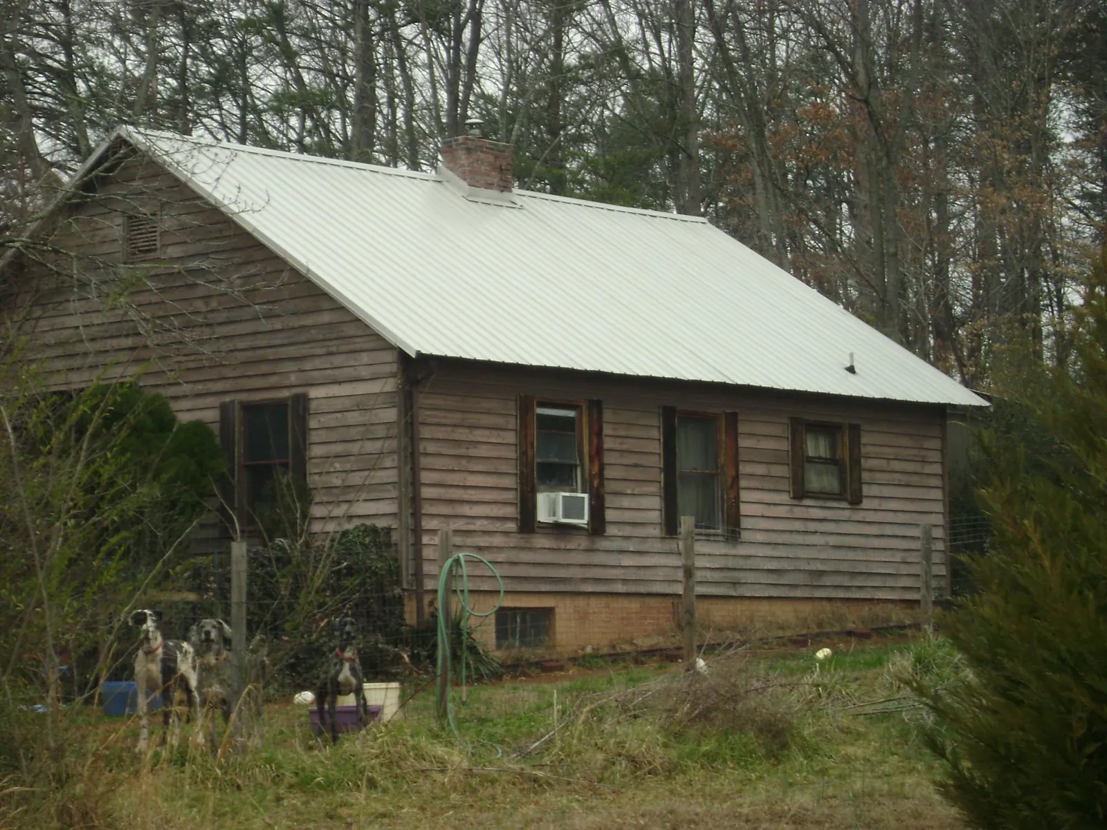 White metal roof on an old wood sided farmhouse, from a Metal Roof Installation job in Gate City